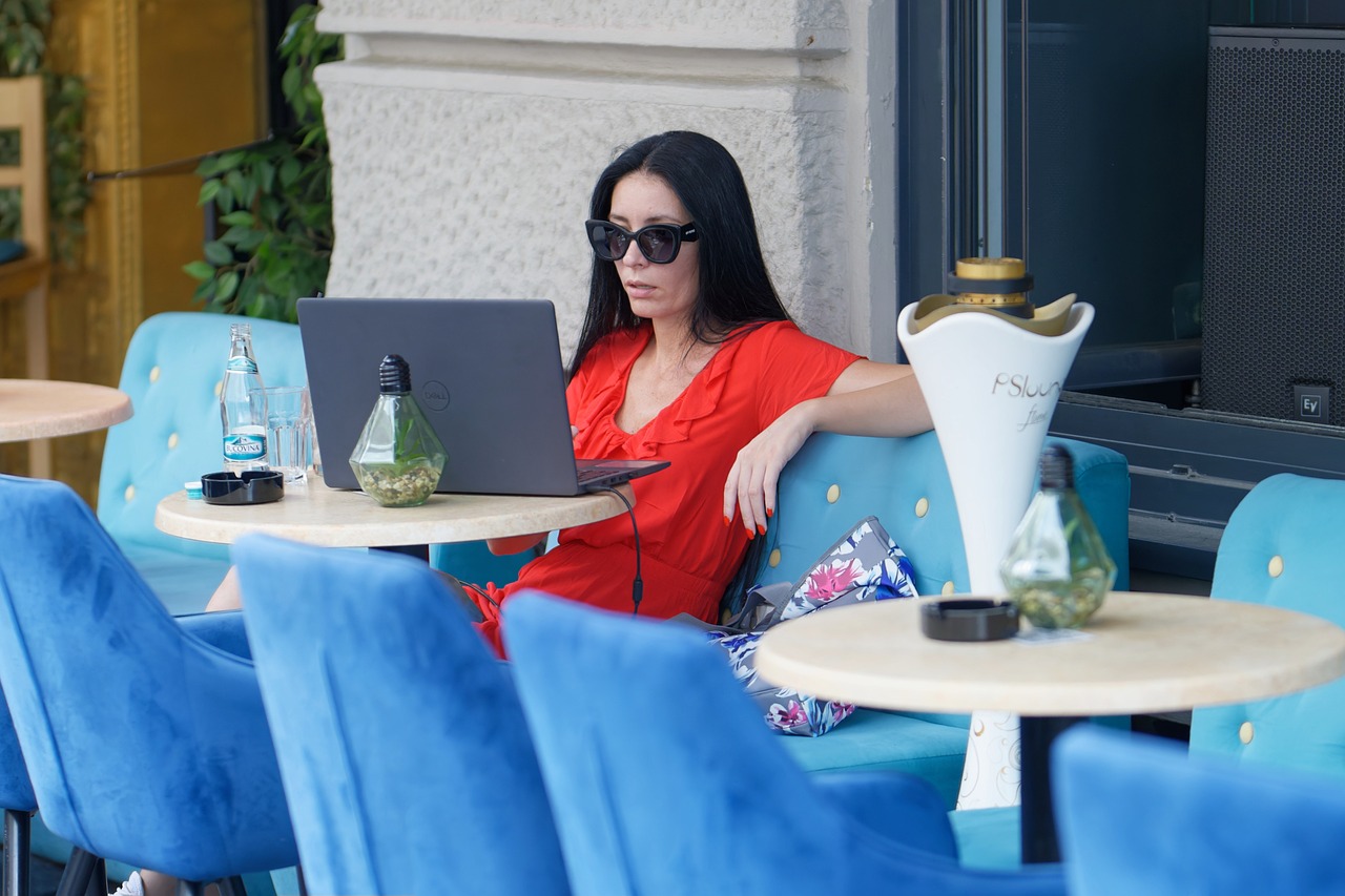 Woman working on a laptop at a cafe